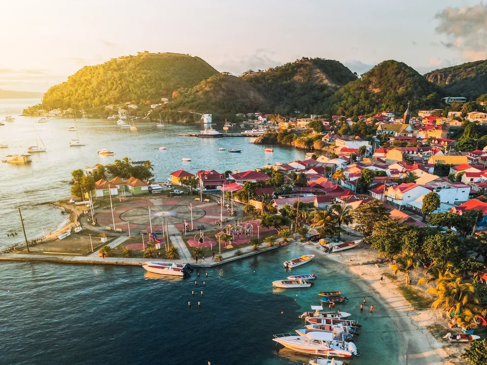 Aerial view of a Guadeloupe bay with boats and colourful waterfront buildings