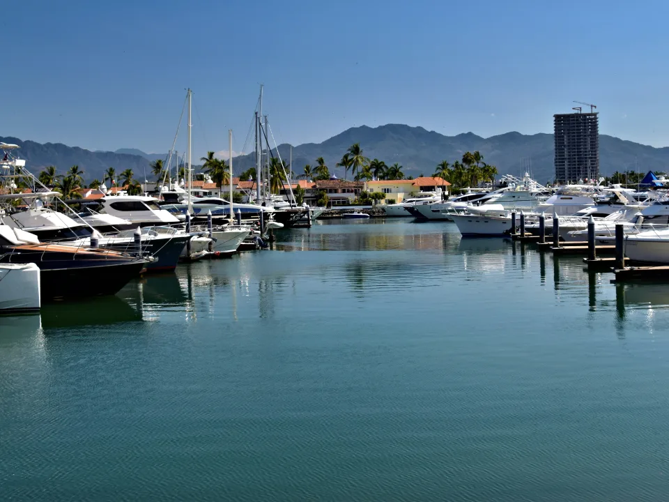 Yachts moored in Puerto Vallarta with mountains beyond the marina, Mexico