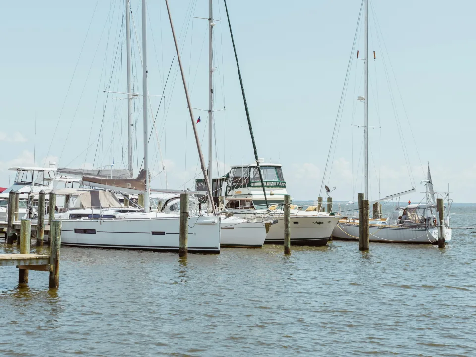 Sailboats moored beside wooden piers at Annapolis on Chesapeake Bay, United States