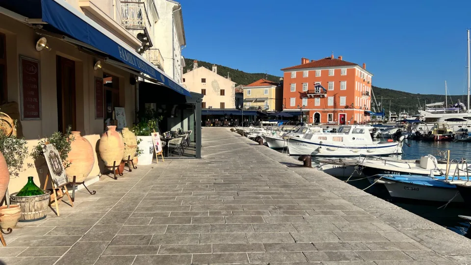 Moored boats and colourful waterfront buildings in Mali Lošinj.