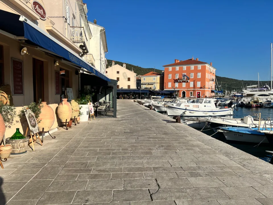 Moored boats and colourful waterfront buildings in Mali Lošinj.