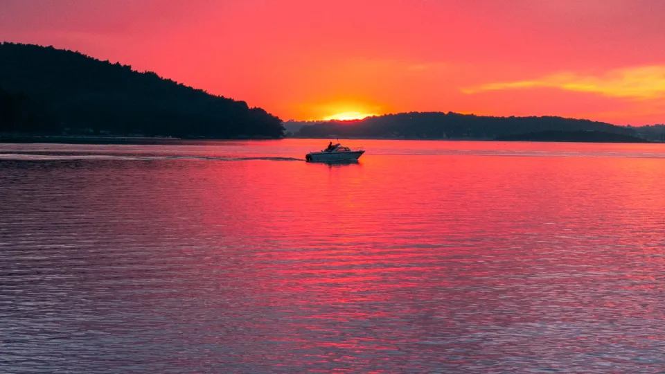 A boat silhouetted against the evening sky over Medulin Bay.