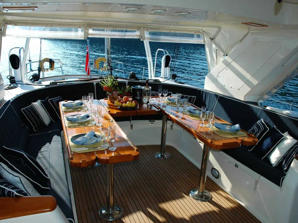A dining table and seating on a yacht deck.