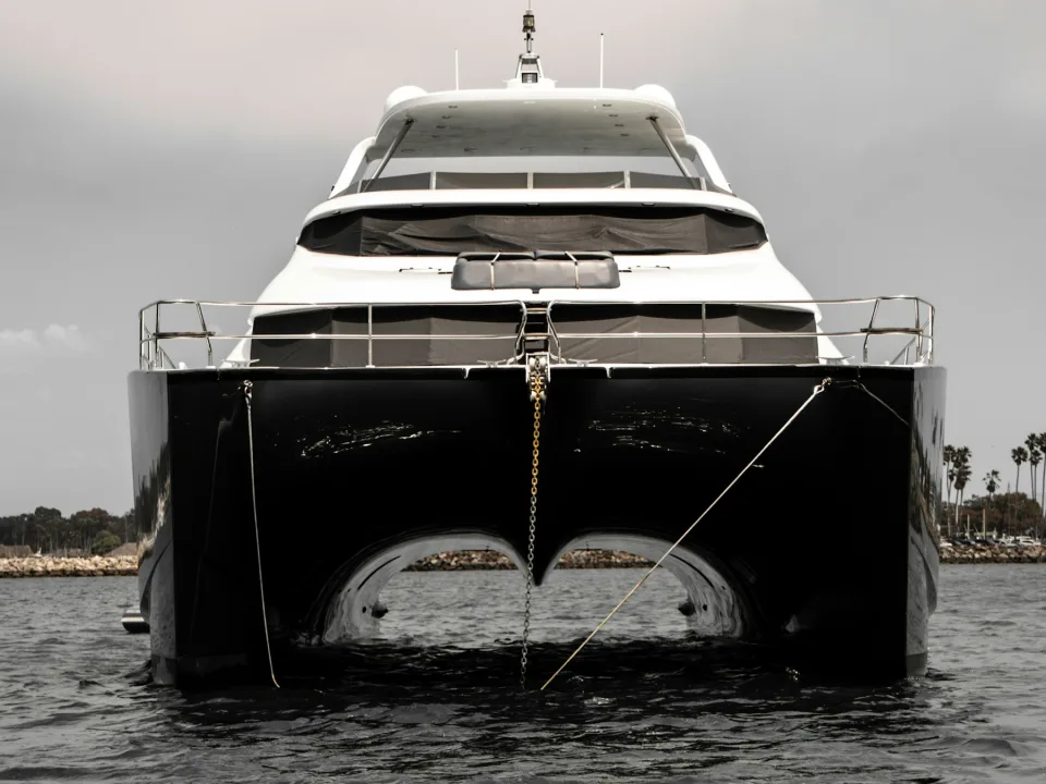 Front view of a power catamaran with twin hulls.