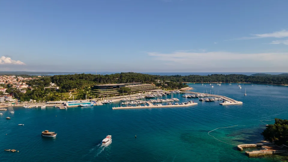 Aerial view of a marina and wooded shoreline near Rovinj.