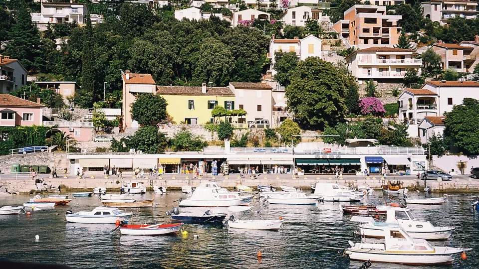 Small boats and hillside houses along the Rabac waterfront