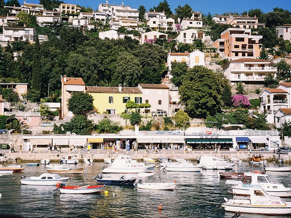 Small boats and hillside houses along the Rabac waterfront