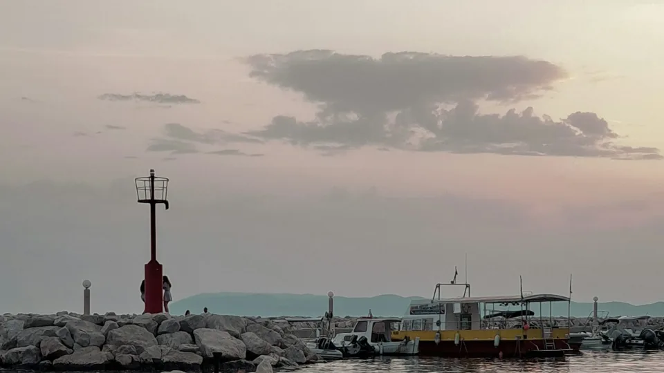 Harbour beacon and moored boats at Tučepi at sunset