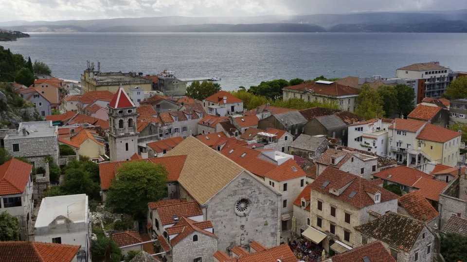 Omiš rooftops and church tower with the sea beyond
