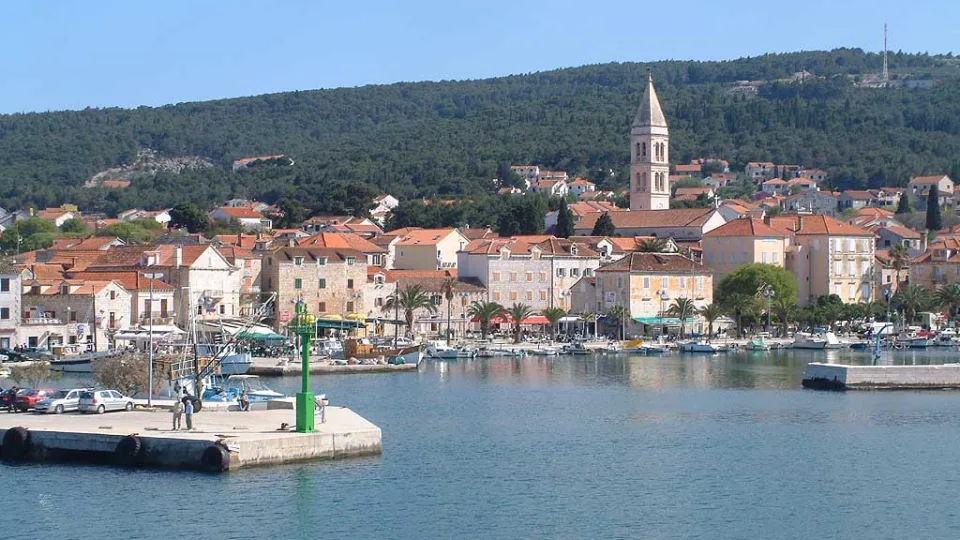 Supetar harbour with waterfront buildings and church tower