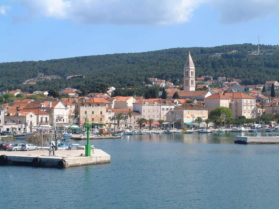 Supetar harbour with waterfront buildings and church tower