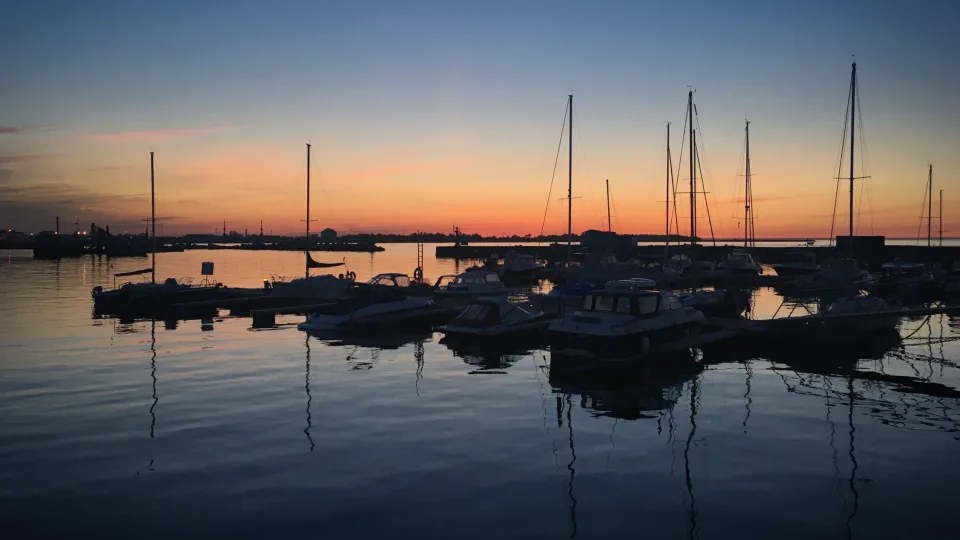 Moored boats and mast reflections at sunset in Kalamaja, Tallinn