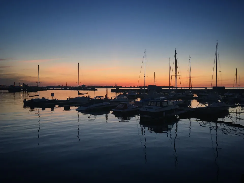 Moored boats and mast reflections at sunset in Kalamaja, Tallinn