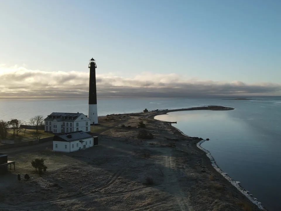 Lighthouse and low buildings beside the coast on Saaremaa