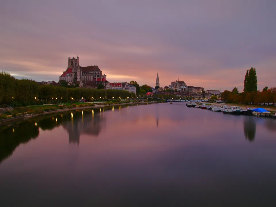 Regional river context: the Auxerre waterfront and boats at sunset