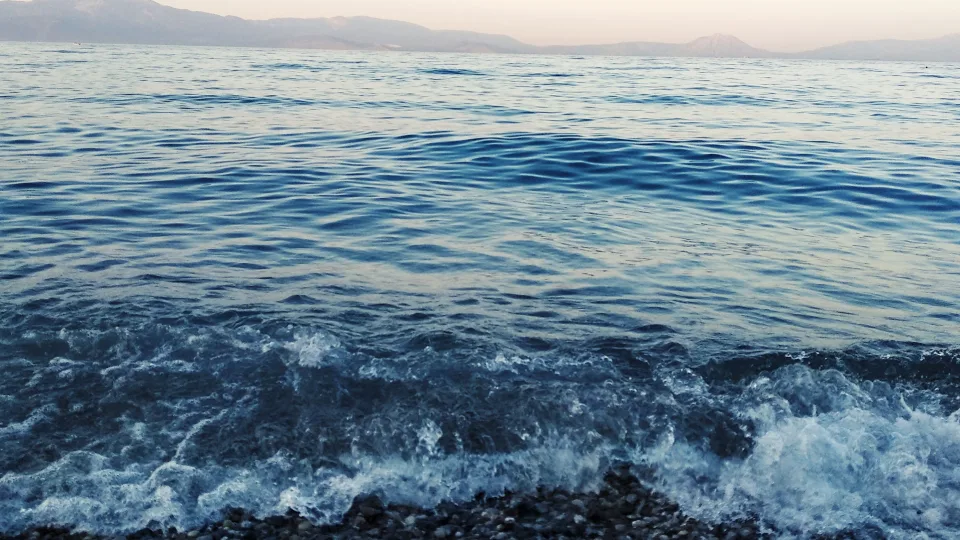 Waves reaching a pebbly beach at Kiato