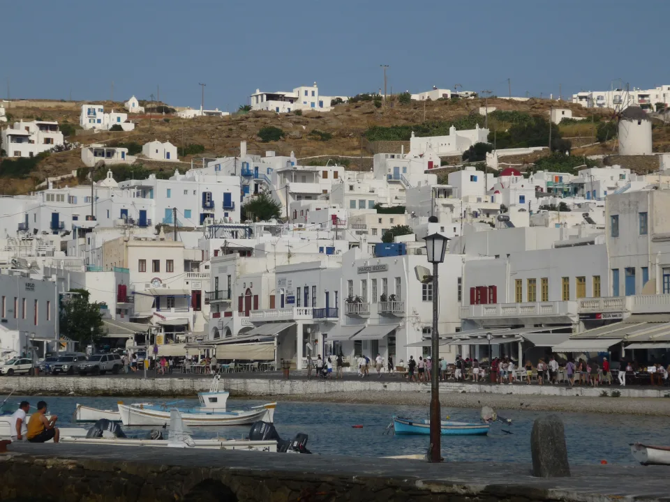 Regional view of white houses and boats on the Mykonos town waterfront
