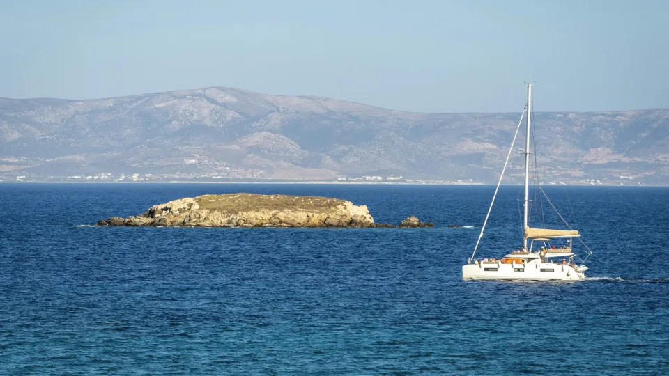 Regional view of a catamaran and rocky islet off Paros