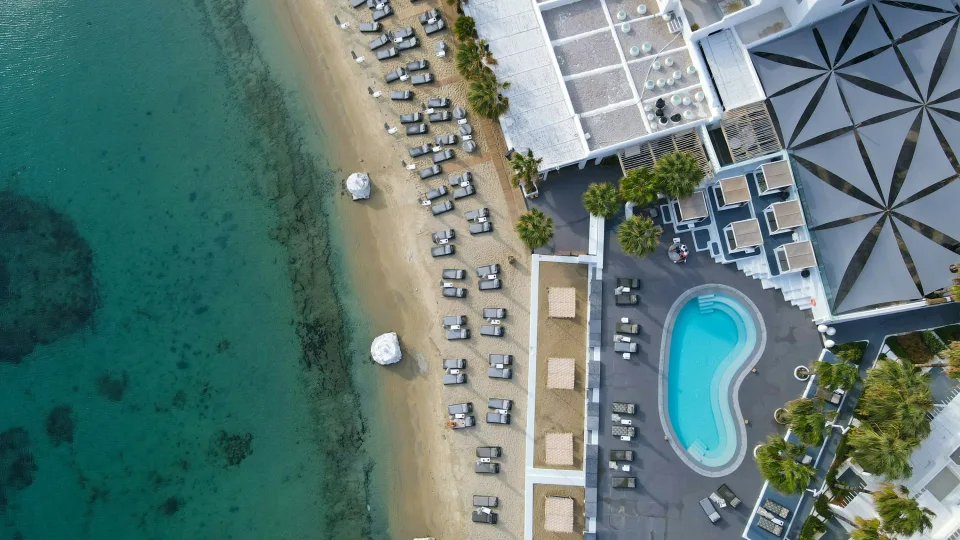 Aerial view of Ornos beach and its white coastal buildings