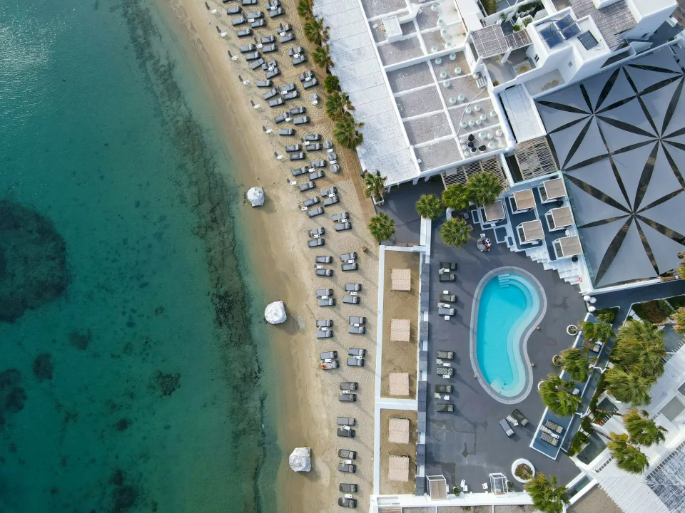 Aerial view of Ornos beach and its white coastal buildings