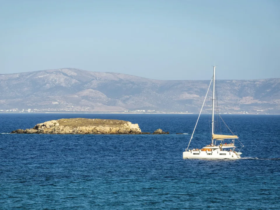 Regional view of a catamaran and rocky islet off Paros