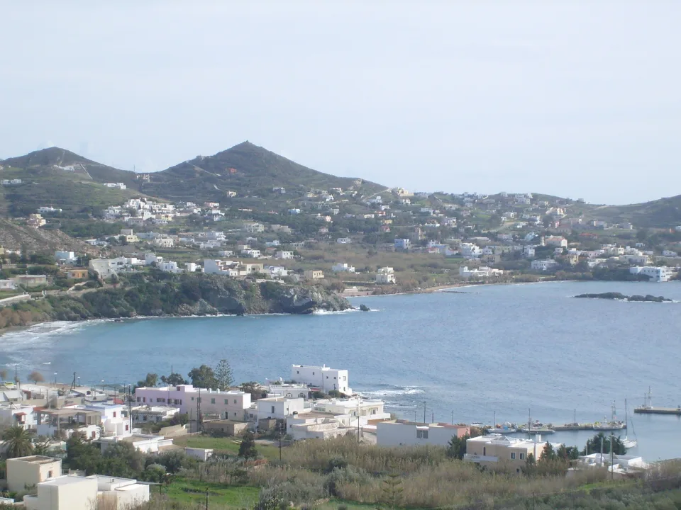 Finikas bay on Syros with hillside houses and the harbour at the shore