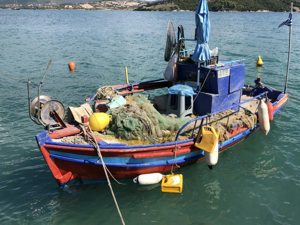 Colourful fishing boat with nets at Lygia on Lefkada