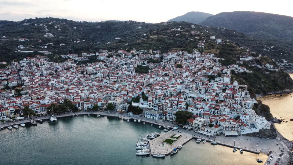 Aerial view of Skopelos town, harbour and wooded hills
