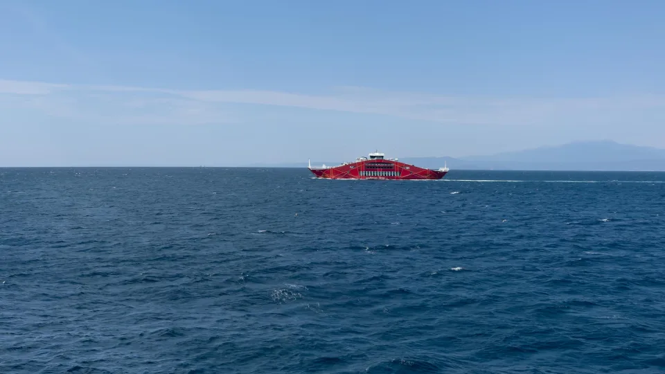 Passenger ferry ANAX on the sea near Keramoti with distant coast behind