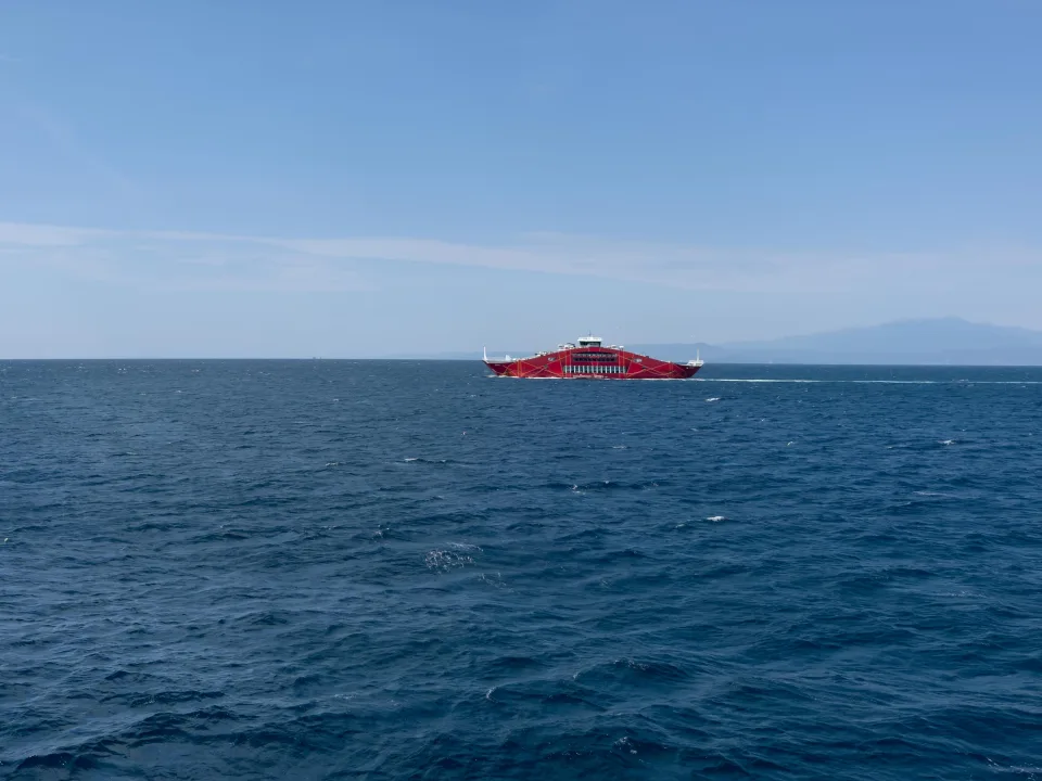 Passenger ferry ANAX on the sea near Keramoti with distant coast behind