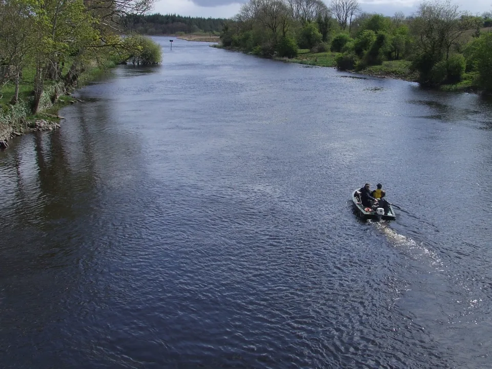 The River Shannon at Drumsna in Ireland, with tree-lined banks and a small fishing dinghy