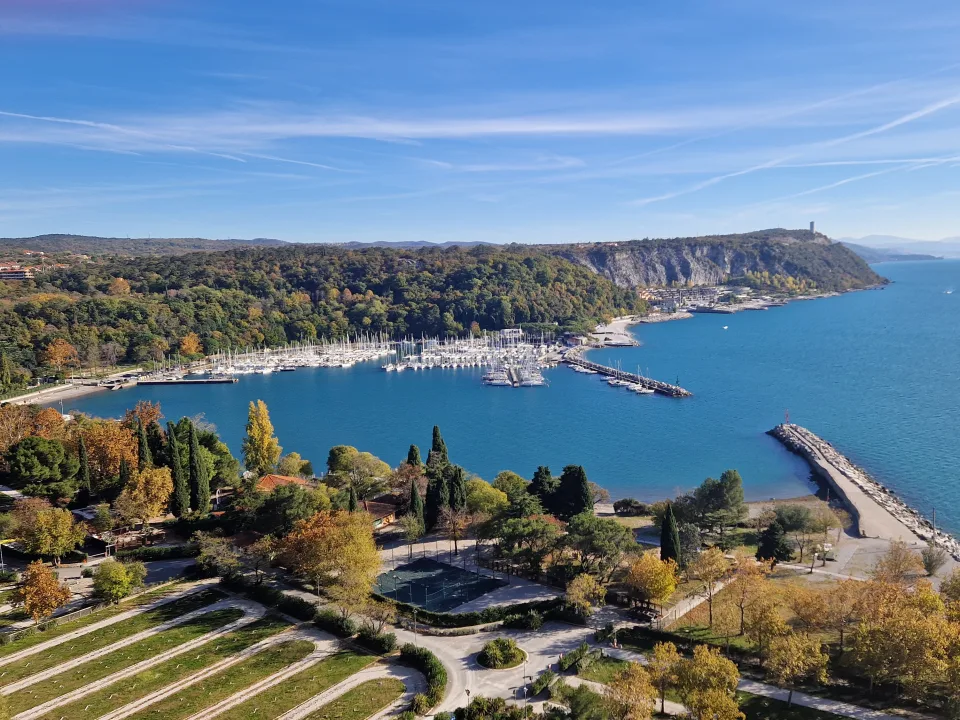 Sistiana Bay with boats and the wooded coastline