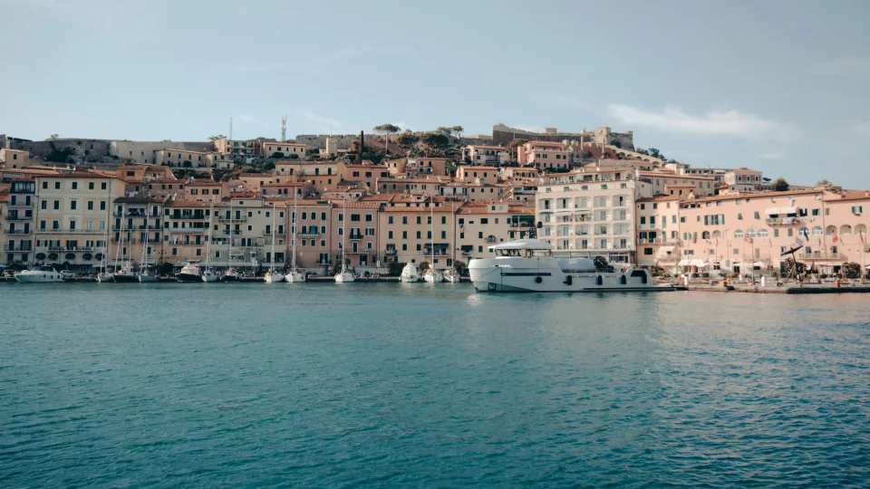 Portoferraio waterfront with boats beneath the old town