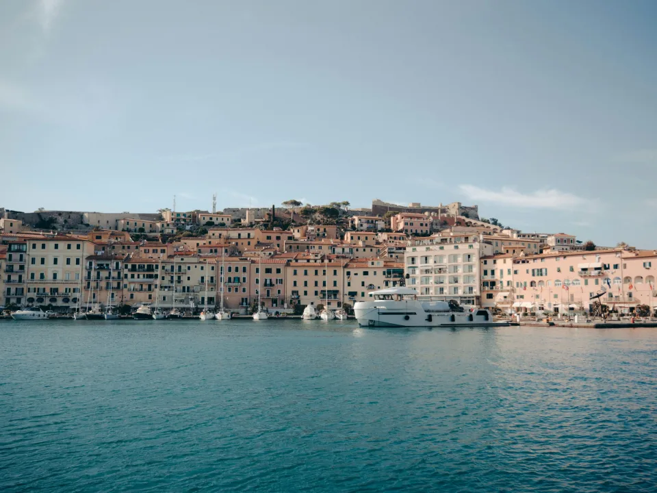 Portoferraio waterfront with boats beneath the old town
