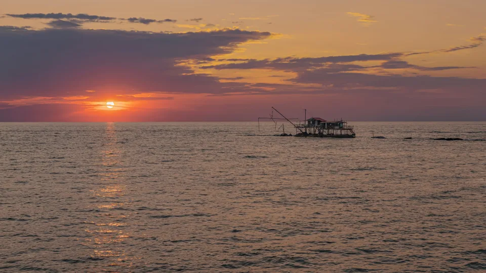 Sunset and fishing structures off Marina di Pisa