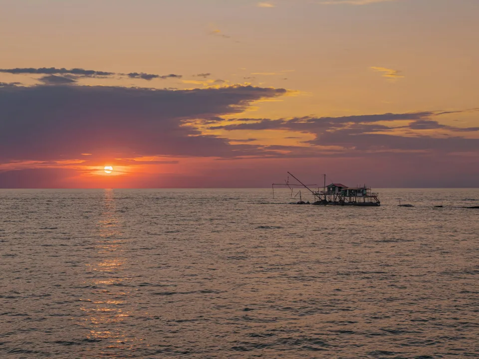 Sunset and fishing structures off Marina di Pisa