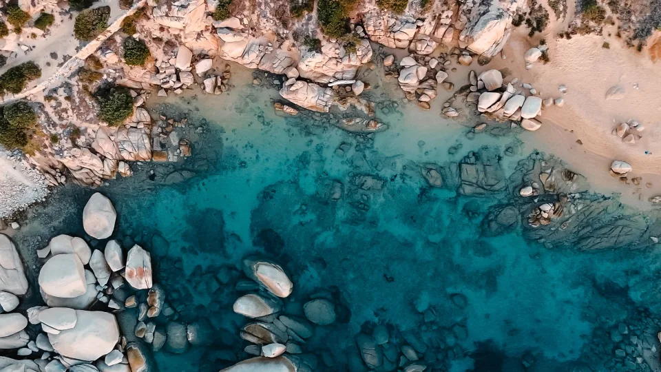 Aerial view of granite rocks, sand and turquoise water at Porto Pollo, Sardinia