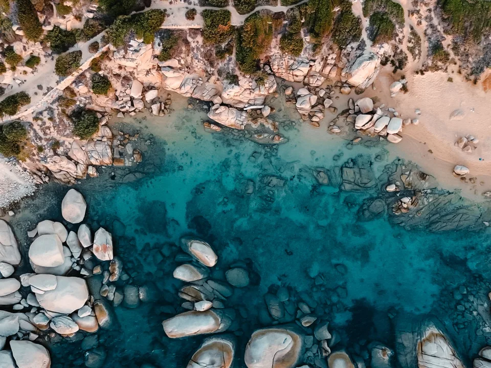 Aerial view of granite rocks, sand and turquoise water at Porto Pollo, Sardinia