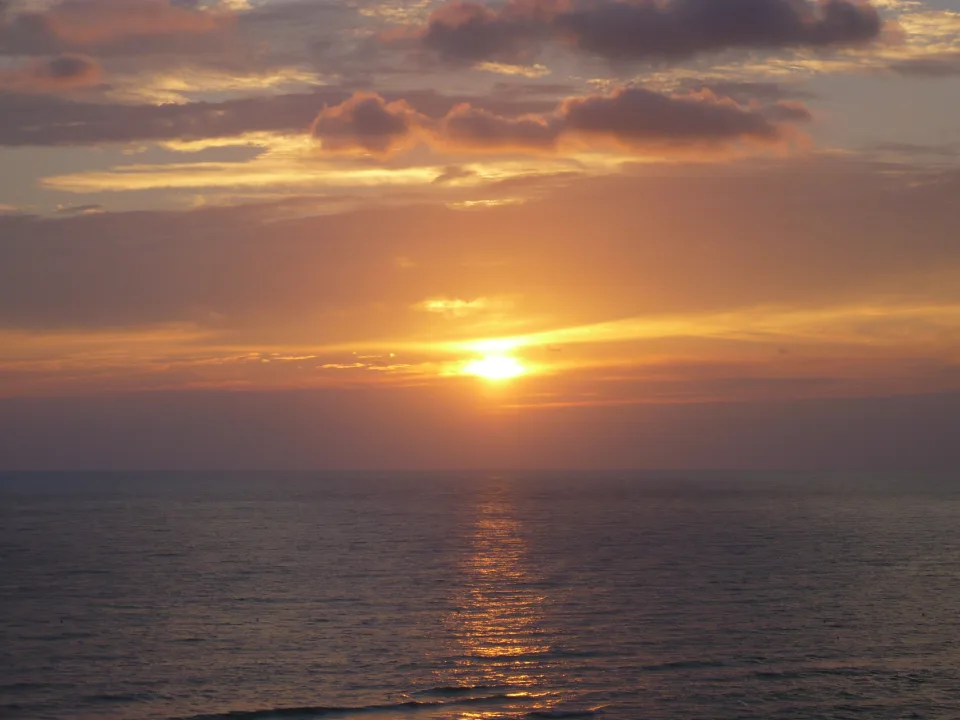 Sunset over the sea at Anzio with warm light reflected on the water