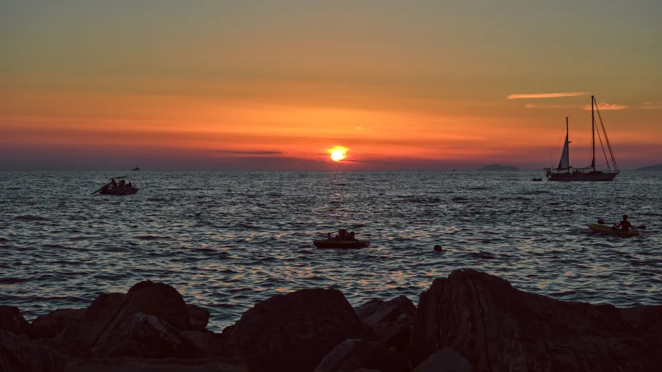 Regional coastal context: a sailing yacht and sunset at Santa Maria di Castellabate on the Cilento coast