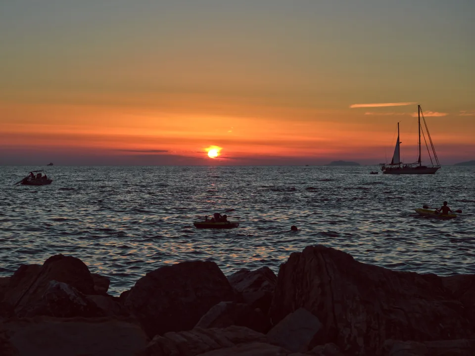 Regional coastal context: a sailing yacht and sunset at Santa Maria di Castellabate on the Cilento coast