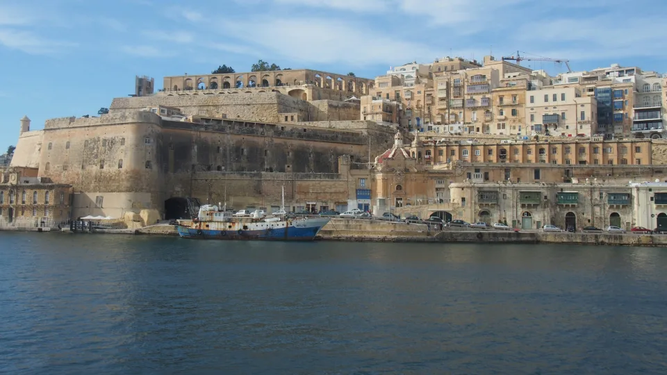 Valletta waterfront and limestone fortifications beside harbour water