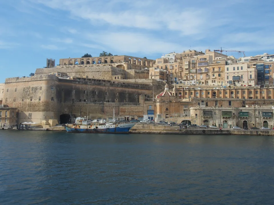 Valletta waterfront and limestone fortifications beside harbour water