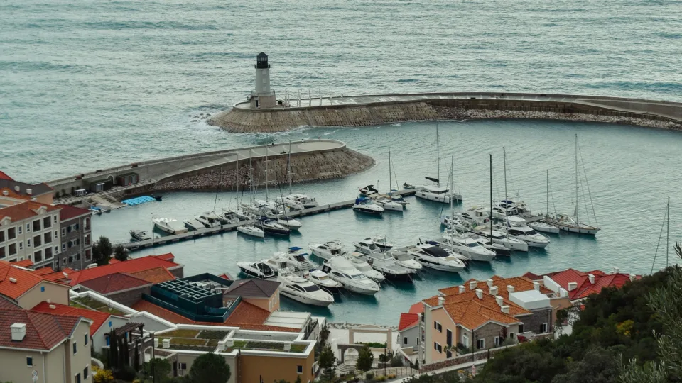 Luštica Bay harbour with moored boats and a breakwater near Radovići