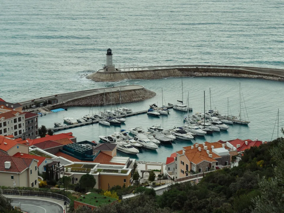 Luštica Bay harbour with moored boats and a breakwater near Radovići