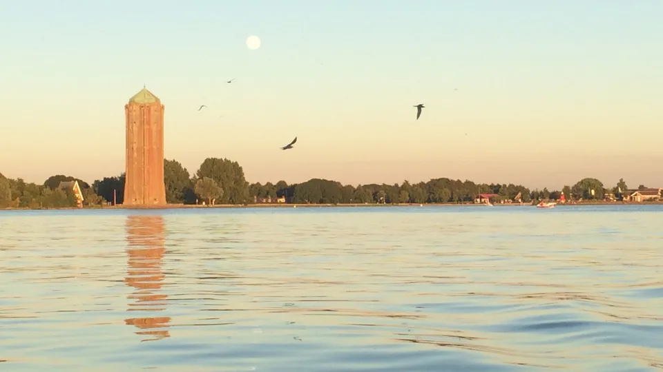 Westeinderplas with Aalsmeer water tower along the wooded shore
