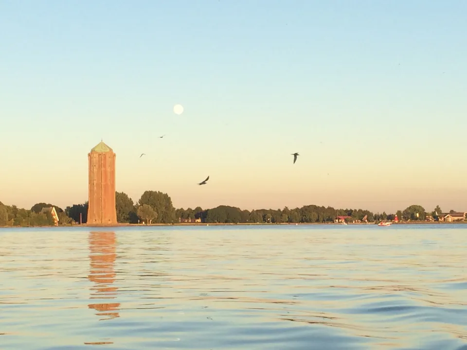 Westeinderplas with Aalsmeer water tower along the wooded shore