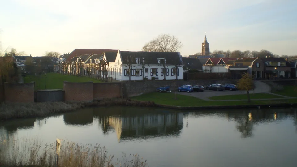 Regional waterway context: river Linge beside historic waterfront buildings at nearby Asperen