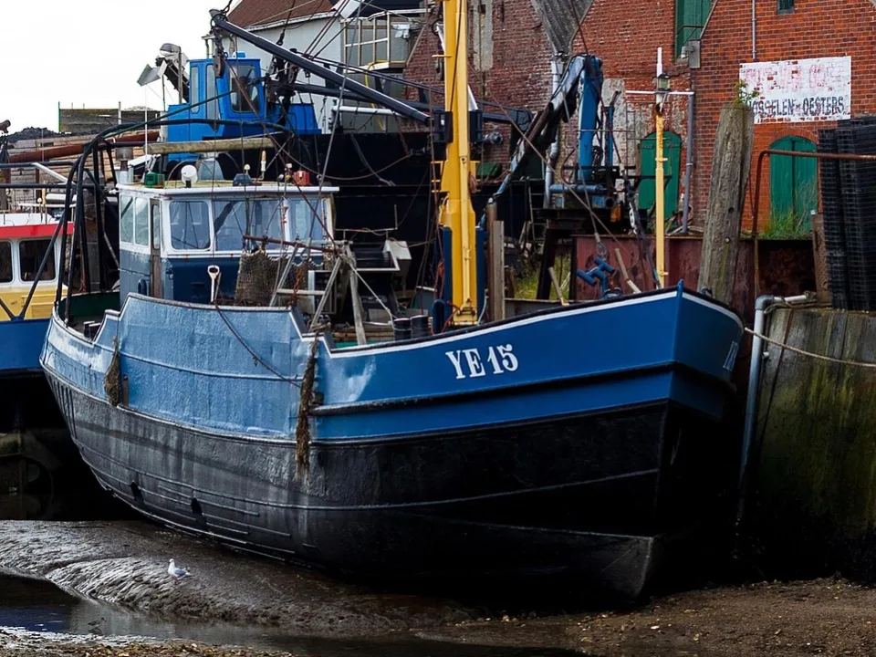 Fishing cutters beside the quay at low tide in Yerseke