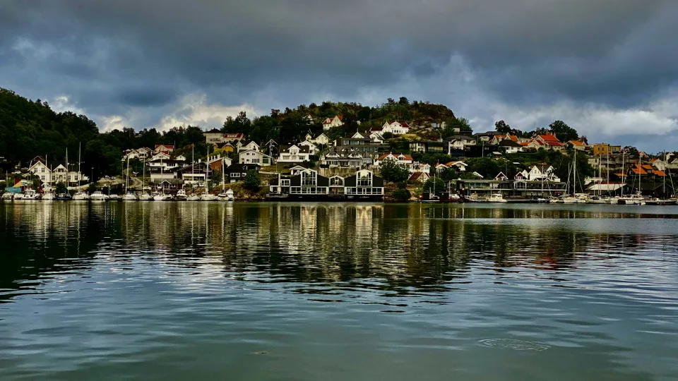 River and reflected hillside houses in Porsgrunn, Norway
